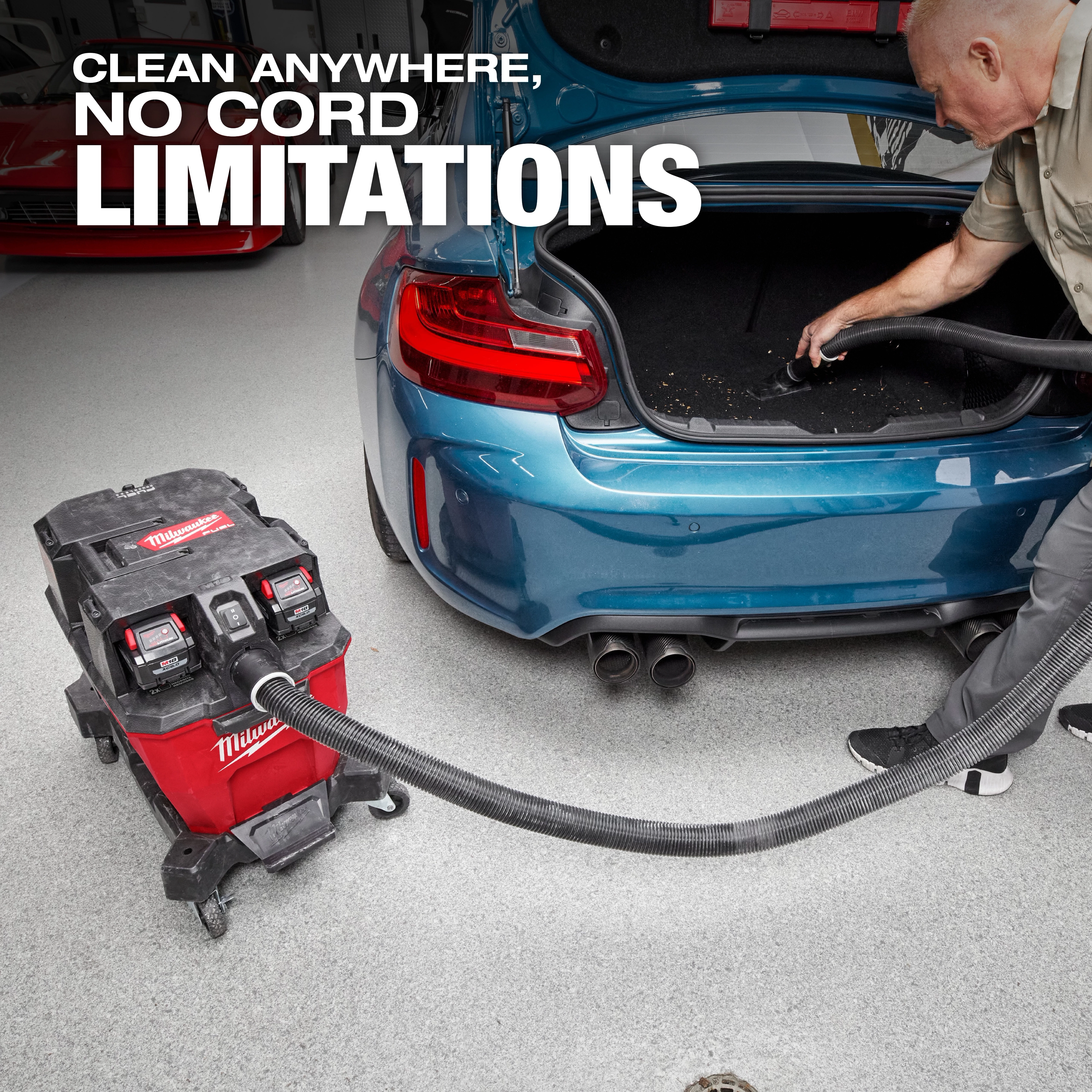 The M18 FUEL™ NEXUS™ 9 Gallon Dual-Battery Wet/Dry Vacuum is being used to clean the trunk of a blue car. The vacuum is cordless and prominently displays the slogan "Clean Anywhere, No Cord Limitations."
