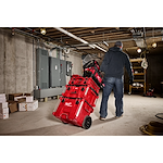 Image of the Milwaukee PACKOUT 15" Structured Tote and PACKOUT Rolling Toolbox being used by a worker on the jobsite