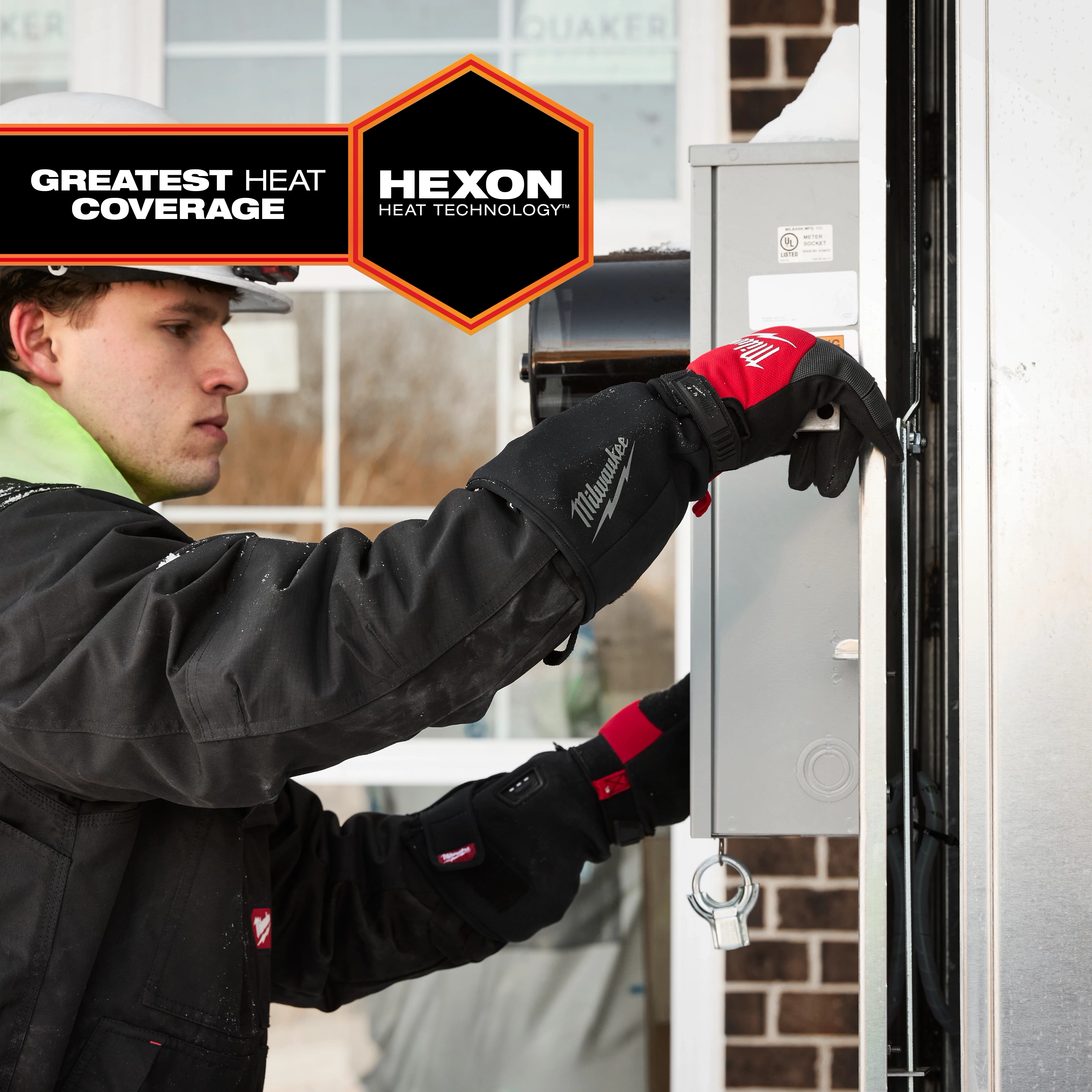 A person wearing black Milwaukee-branded Heated Work Glove Liners is seen working on an electrical box. The image highlights the gloves' "Greatest Heat Coverage" and "Hexon Heat Technology."