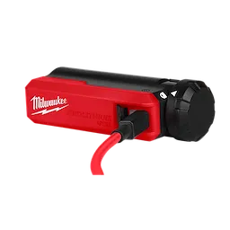 The image shows the REDLITHIUM™ USB Charger and Portable Power Source Kit by Milwaukee. The device is red and black with a USB port and a connected red USB cable, designed for charging and power supply.