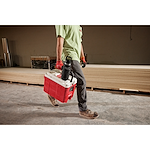 Image of a worker carrying a Milwaukee Cooler with a PACKOUT Insulated Bottle with Chug Lid in black